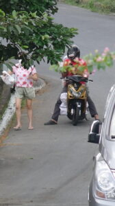 People on the streets talking with motor cycle